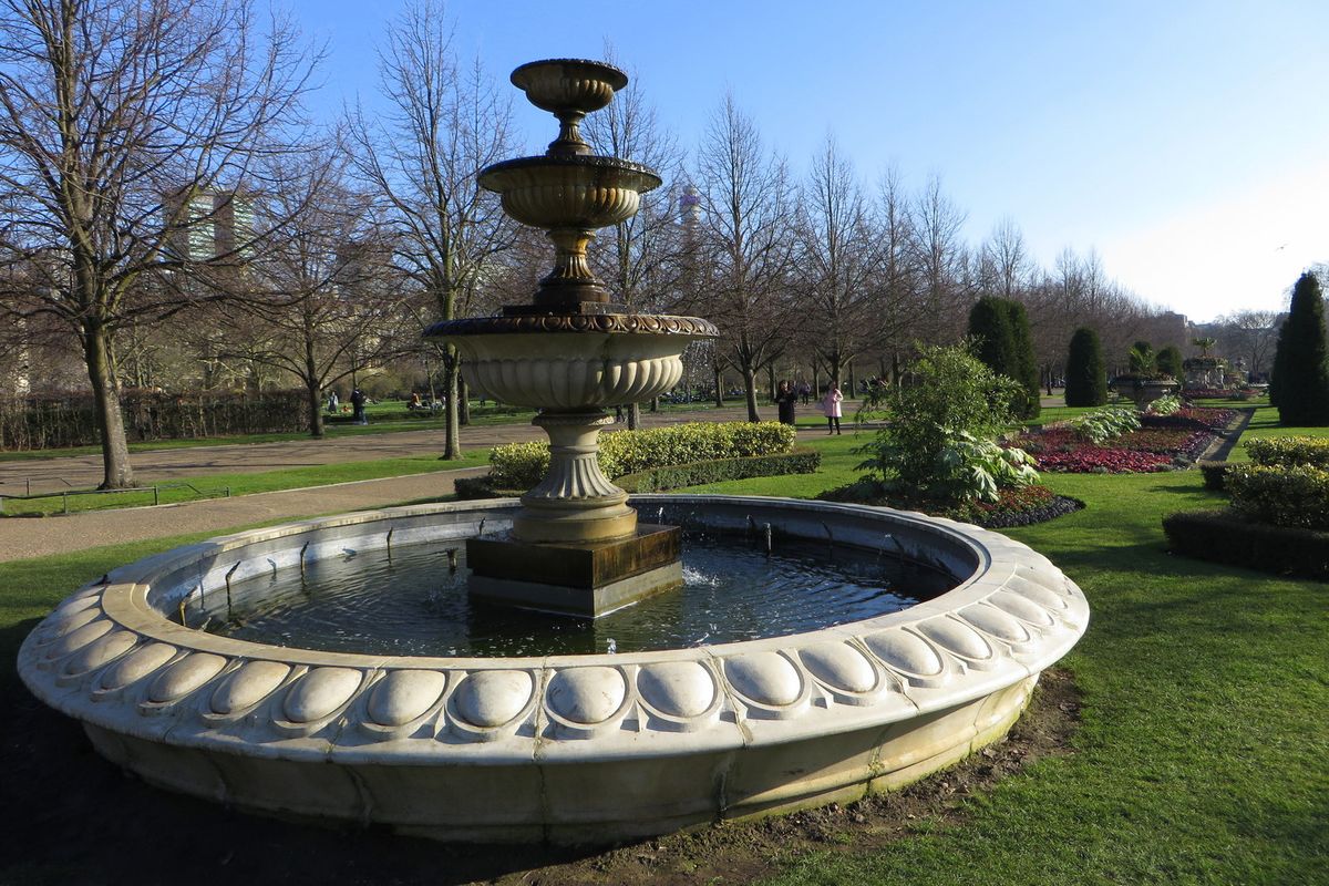 Stone fountain and flower beds in the English Gardens of The Regent's Park
